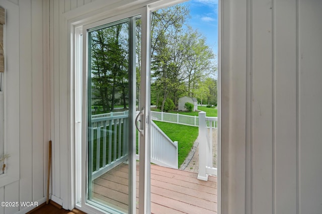 doorway to outside featuring wood walls and a healthy amount of sunlight