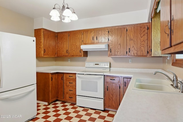 kitchen featuring a sink, light countertops, light floors, under cabinet range hood, and white appliances