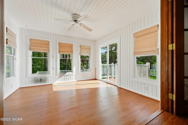 unfurnished sunroom featuring wood ceiling and wood finished floors
