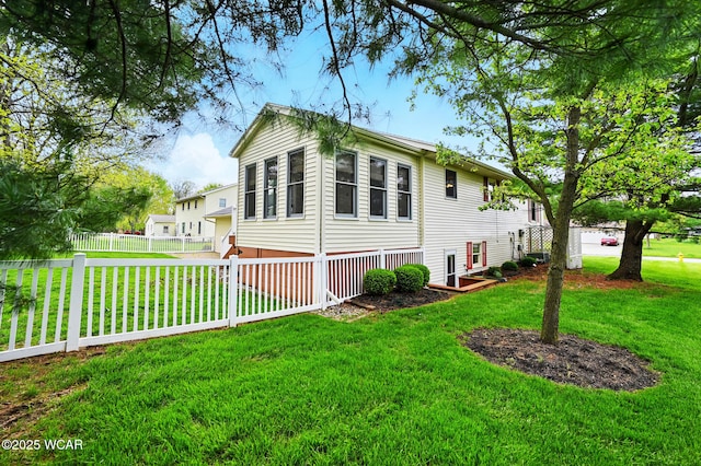 manufactured / mobile home with a fenced backyard and a front lawn