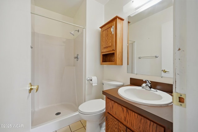 bathroom featuring vanity, tile patterned flooring, a stall shower, and toilet