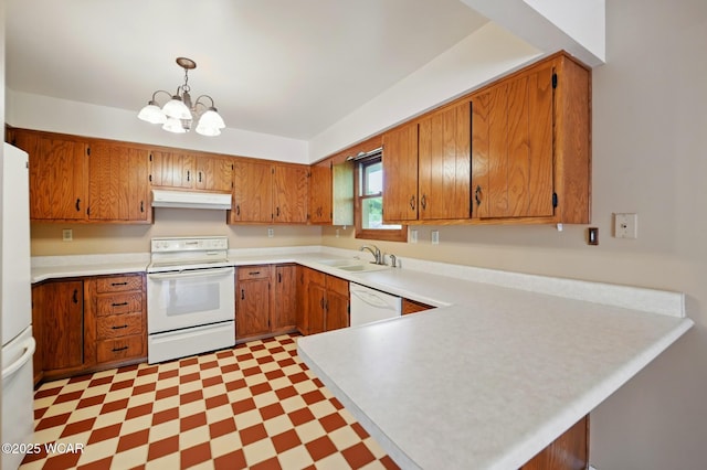 kitchen with a sink, under cabinet range hood, white appliances, and light countertops