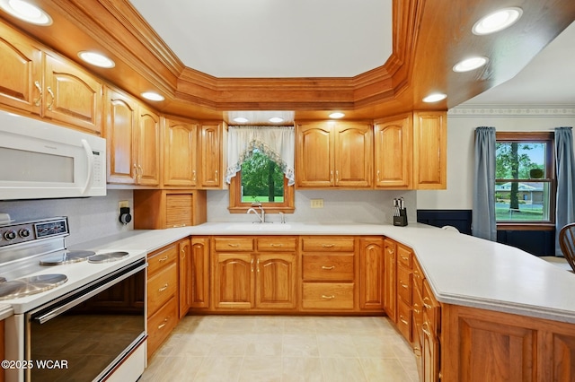 1317 Melrose St, Lima, OH 45801 - kitchen featuring white appliances, a peninsula, light countertops, a tray ceiling, and light tile patterned floors