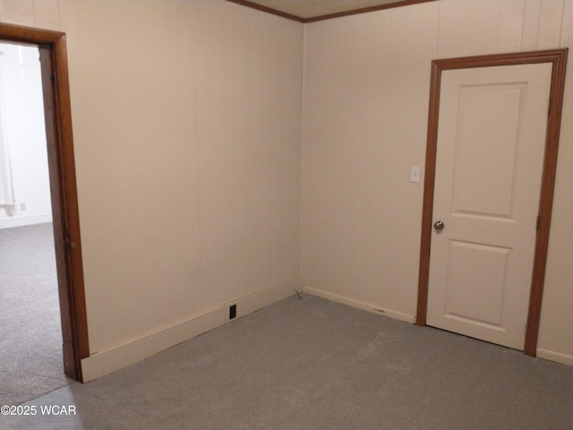 empty room with carpet floors and ornamental molding