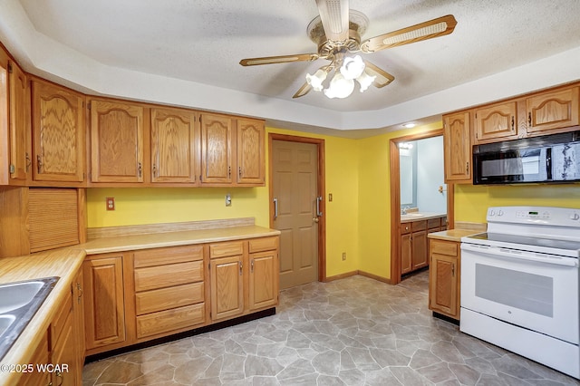 kitchen with black microwave, white range with electric stovetop, light countertops, and ceiling fan