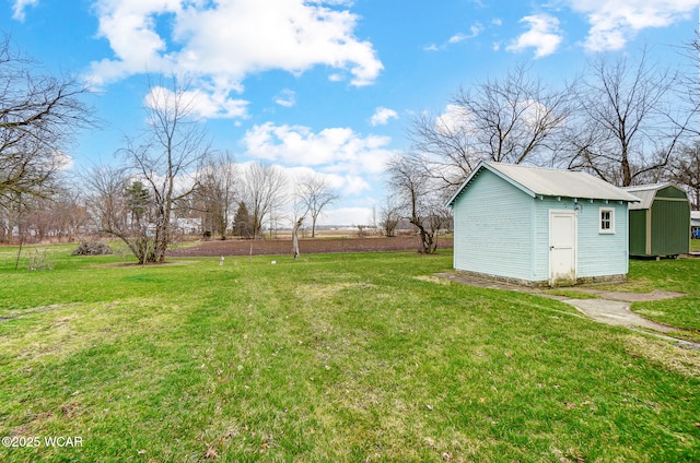 view of yard featuring an outbuilding and a storage shed