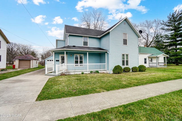 view of front of property featuring a front lawn, covered porch, an outdoor structure, and a detached garage