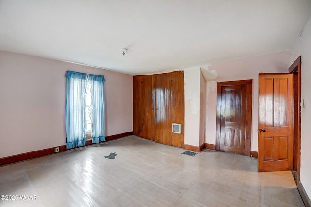 empty room with baseboards and visible vents