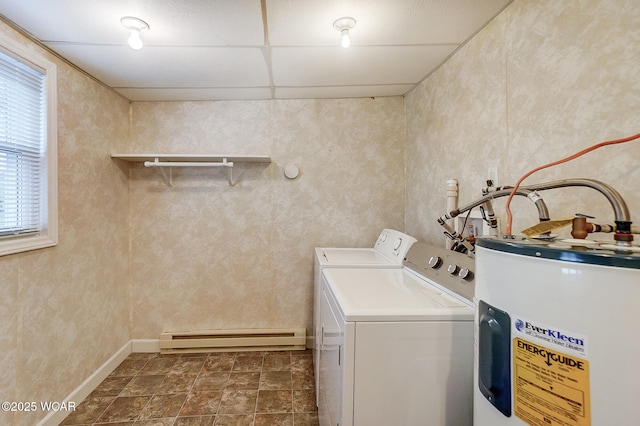 laundry area featuring baseboards, laundry area, baseboard heating, water heater, and washer and dryer