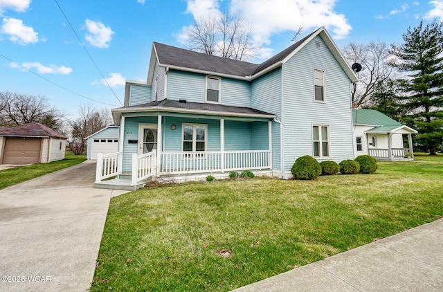 view of front of property featuring a front yard, covered porch, an outdoor structure, and a detached garage