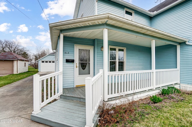 property entrance featuring covered porch and a detached garage