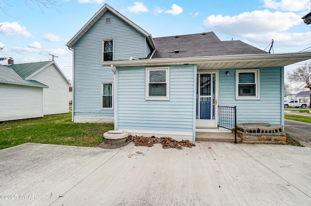 rear view of house featuring a lawn