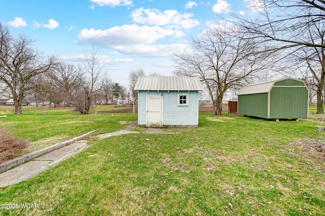 view of yard with an outbuilding and a shed