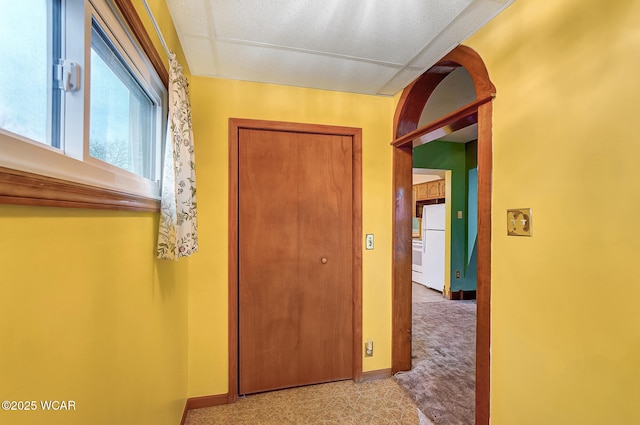 hallway featuring baseboards