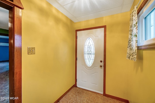 entrance foyer featuring baseboards and a wealth of natural light