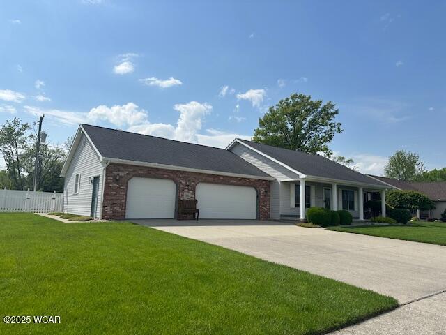 1461 Cessna Ave, Lima, OH 45807 - ranch-style home with a garage, concrete driveway, and brick siding