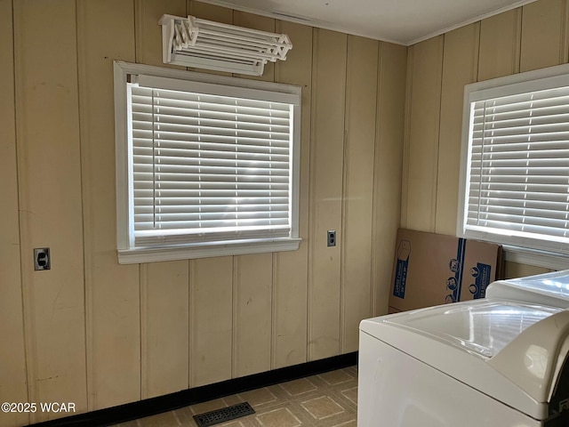 clothes washing area with tile patterned floors, laundry area, plenty of natural light, and visible vents