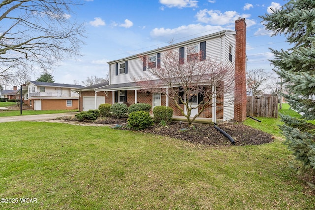 traditional-style home featuring a front lawn, brick siding, a chimney, a garage, and concrete driveway