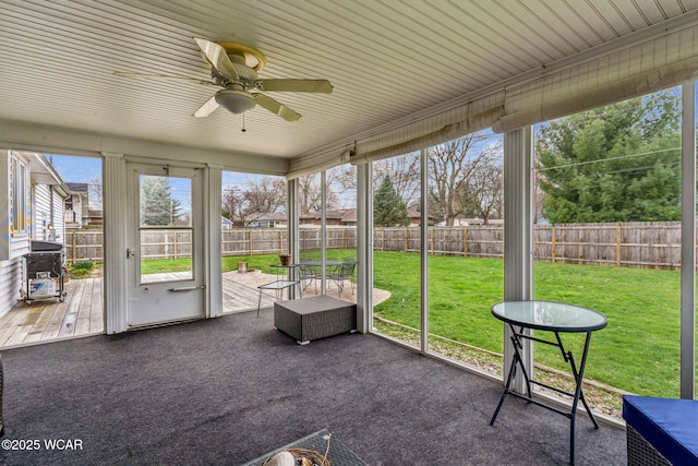 sunroom with a healthy amount of sunlight and ceiling fan
