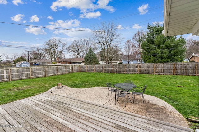 deck featuring a patio area, a fenced backyard, and a lawn