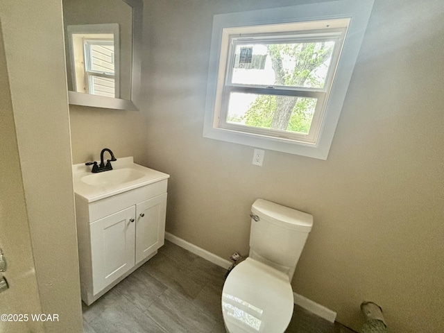 514 Fairview Ave, Lima, OH 45804 - bathroom featuring toilet, baseboards, and vanity