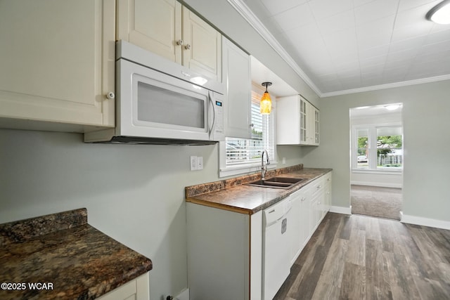 517 Marian Ave, Lima, OH 45801 - kitchen with white appliances, dark wood-style floors, ornamental molding, dark countertops, and healthy amount of natural light