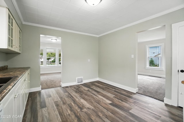 517 Marian Ave, Lima, OH 45801 - unfurnished dining area featuring dark wood finished floors, plenty of natural light, and ornamental molding