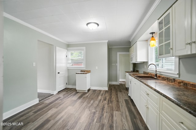517 Marian Ave, Lima, OH 45801 - kitchen featuring dark countertops, glass insert cabinets, dark wood-style floors, white cabinets, and crown molding