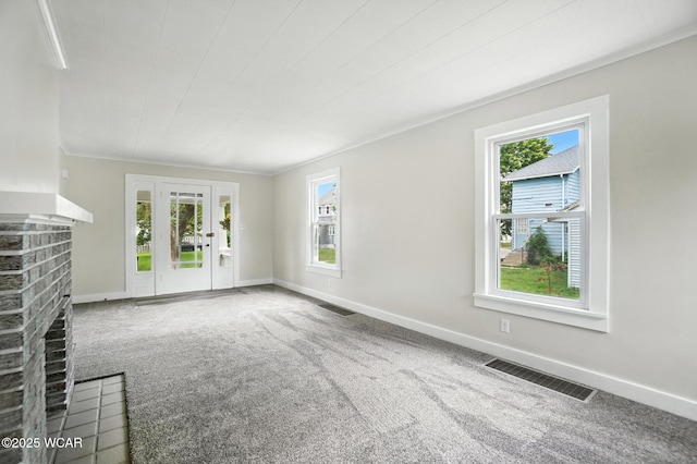 517 Marian Ave, Lima, OH 45801 - unfurnished living room featuring plenty of natural light, a brick fireplace, carpet floors, and ornamental molding