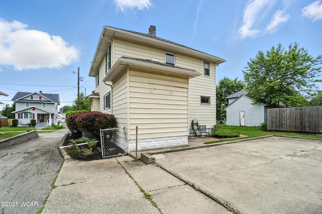 517 Marian Ave, Lima, OH 45801 - view of side of home with a chimney and a gate