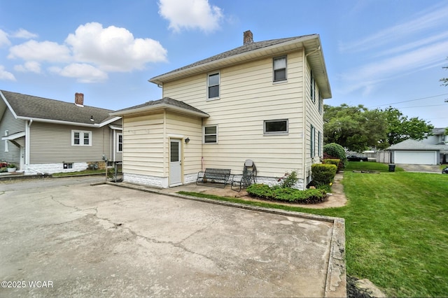 517 Marian Ave, Lima, OH 45801 - back of house with a yard, a patio area, and a chimney