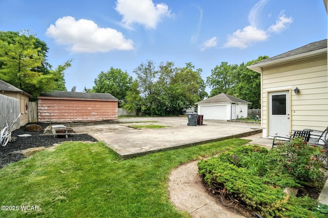 517 Marian Ave, Lima, OH 45801 - view of yard featuring an outbuilding, a detached garage, and a patio