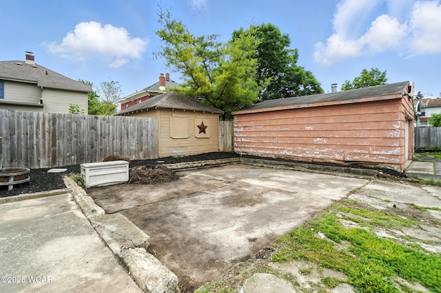 517 Marian Ave, Lima, OH 45801 - fenced backyard with a patio and a storage unit