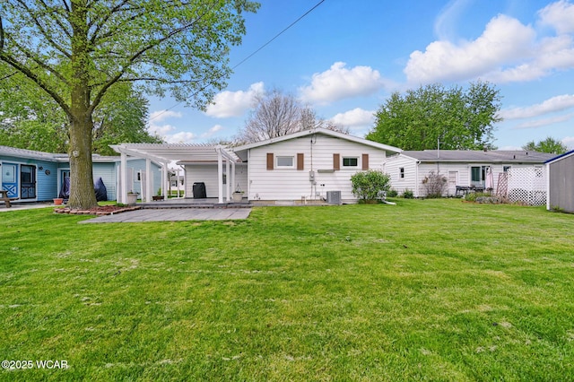 216 N Rauthland Ave, Wapakoneta, OH 45895 - back of property with a pergola, a patio, a lawn, and central AC