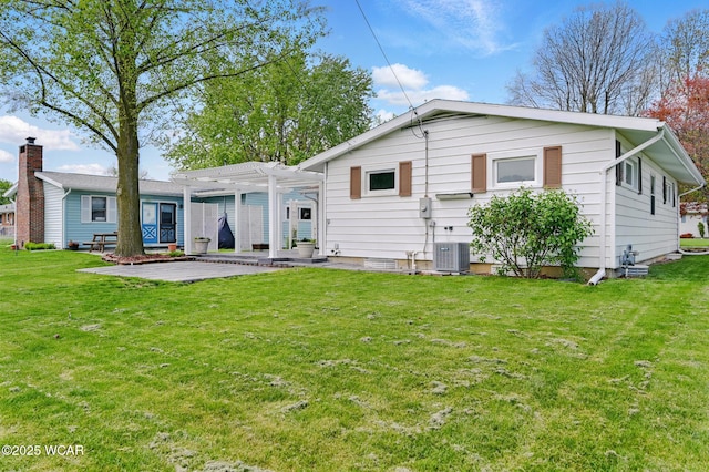 216 N Rauthland Ave, Wapakoneta, OH 45895 - back of property with a pergola, a patio, a yard, and central air condition unit