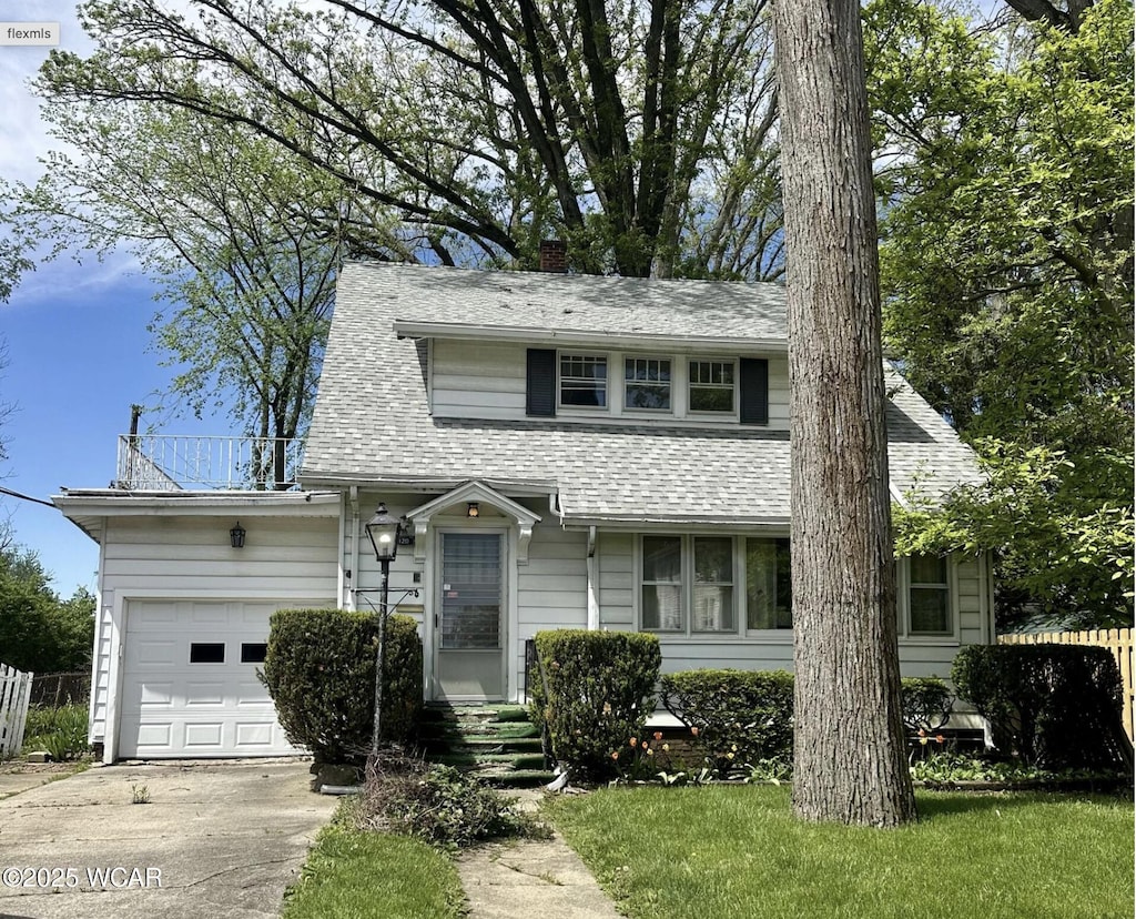 120 S Woodlawn Ave, Lima, OH 45805 - view of front of property featuring a garage, concrete driveway, a chimney, and roof with shingles
