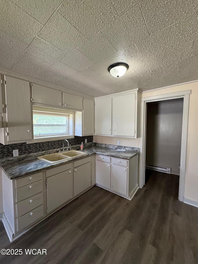 809 King St, Kenton, OH 43326 - kitchen featuring a baseboard heating unit, dark wood finished floors, and white cabinets