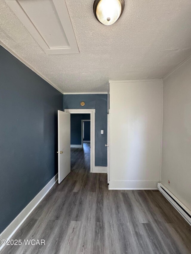 809 King St, Kenton, OH 43326 - spare room with a textured ceiling, a baseboard heating unit, and wood finished floors