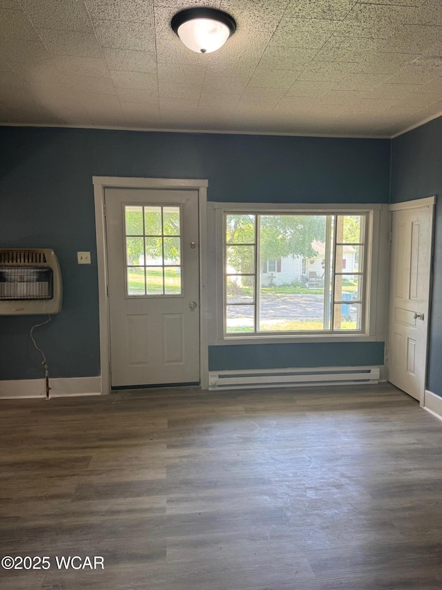 809 King St, Kenton, OH 43326 - doorway with heating unit, baseboard heating, and wood finished floors