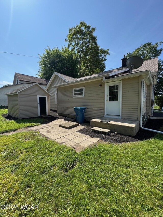 809 King St, Kenton, OH 43326 - rear view of house featuring a shed, a lawn, and a chimney