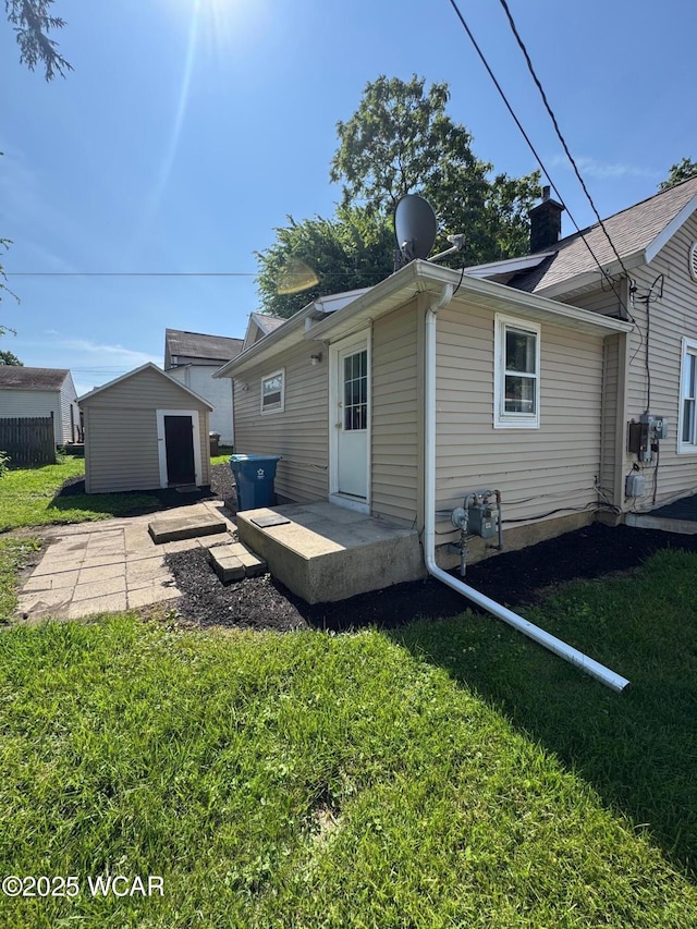 809 King St, Kenton, OH 43326 - back of property with a yard, a storage shed, and a chimney