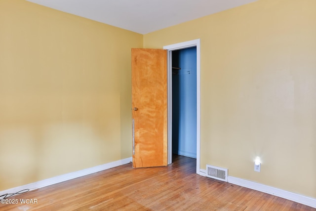 unfurnished bedroom featuring light wood-type flooring, visible vents, and baseboards