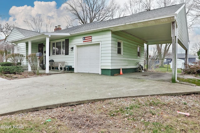 view of front facade with driveway, a shingled roof, a chimney, and an attached carport