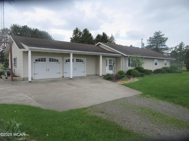 ranch-style home with a front yard, a garage, and driveway