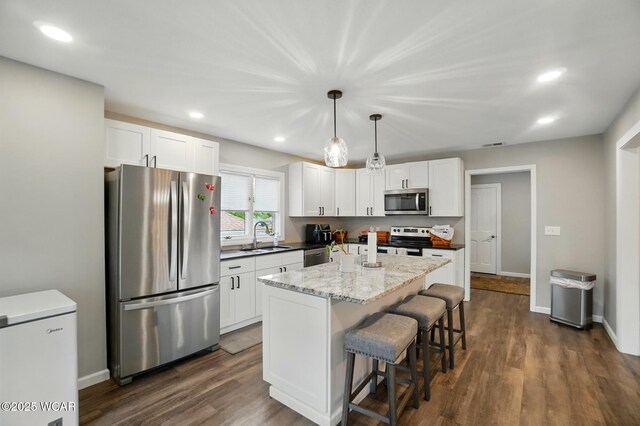 2635 Adgate Rd Unit 1D # 210, Lima, OH 45805 - kitchen with appliances with stainless steel finishes, a sink, white cabinetry, a breakfast bar area, and recessed lighting