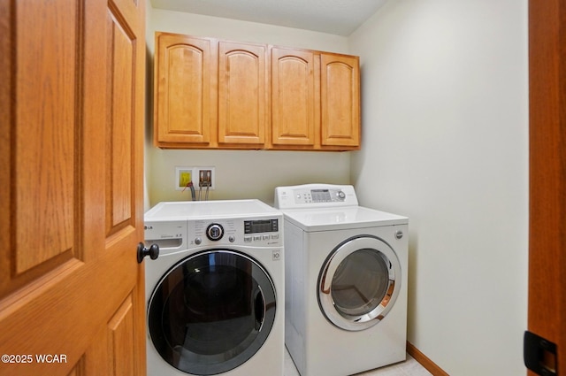 laundry room featuring washing machine and dryer and cabinet space
