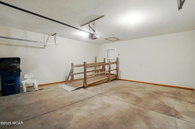 garage with baseboards and a garage door opener