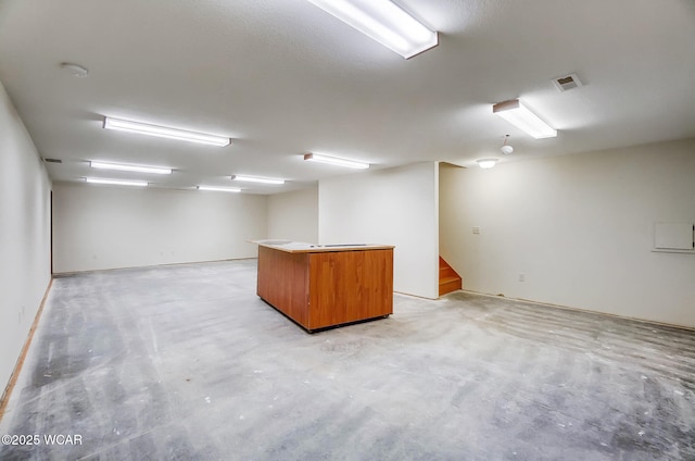 finished basement with visible vents and stairway