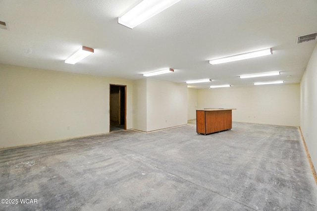 empty room with visible vents and concrete floors