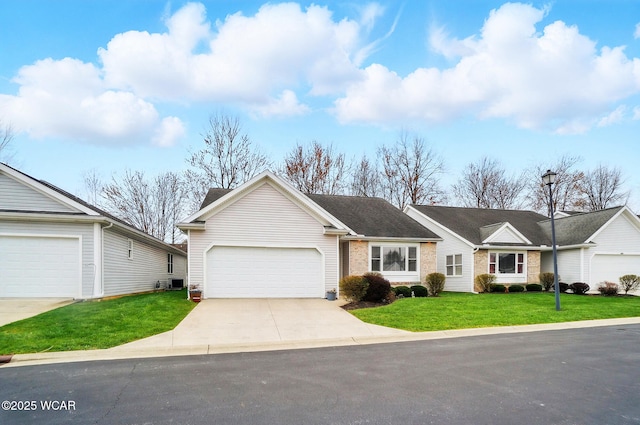 ranch-style house with a garage, brick siding, a front yard, and concrete driveway